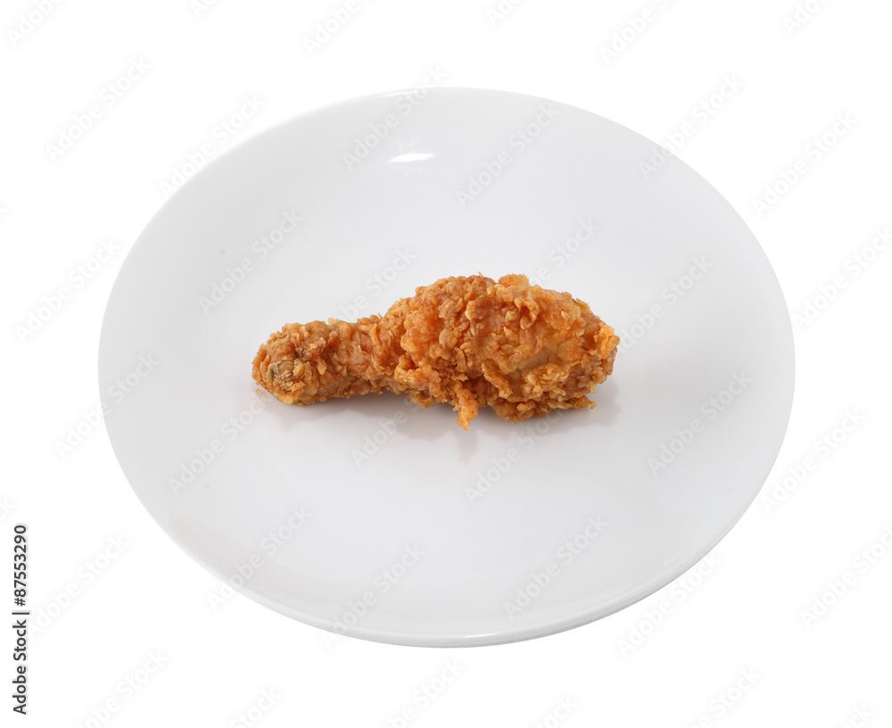 A white plate with fresh, crispy fried chicken A white plate with fresh, crispy fried chicken