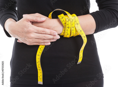 The woman in black with yellow measuring tape on her hand, healt
