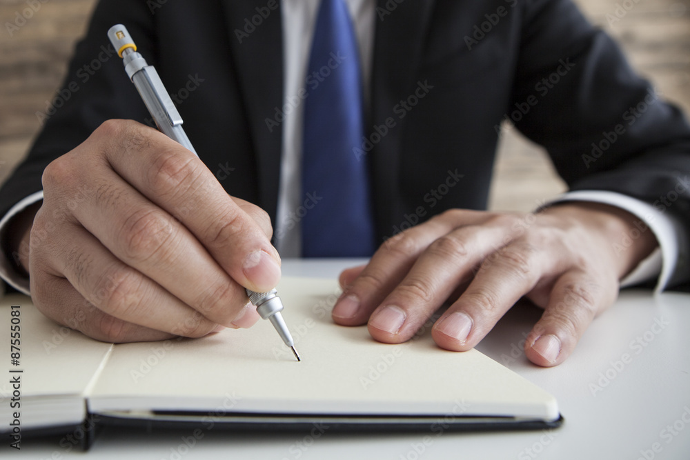 Businessman wrote a plan to notebook Businessman wrote a plan to notebook