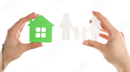 Female hands holding model of house and paper family isolated on white
