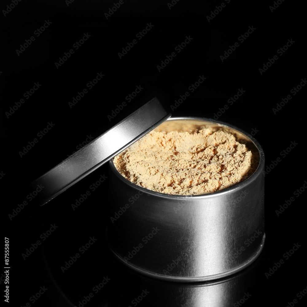 Jar with loose cosmetic powder isolated on black Jar with loose cosmetic powder isolated on black