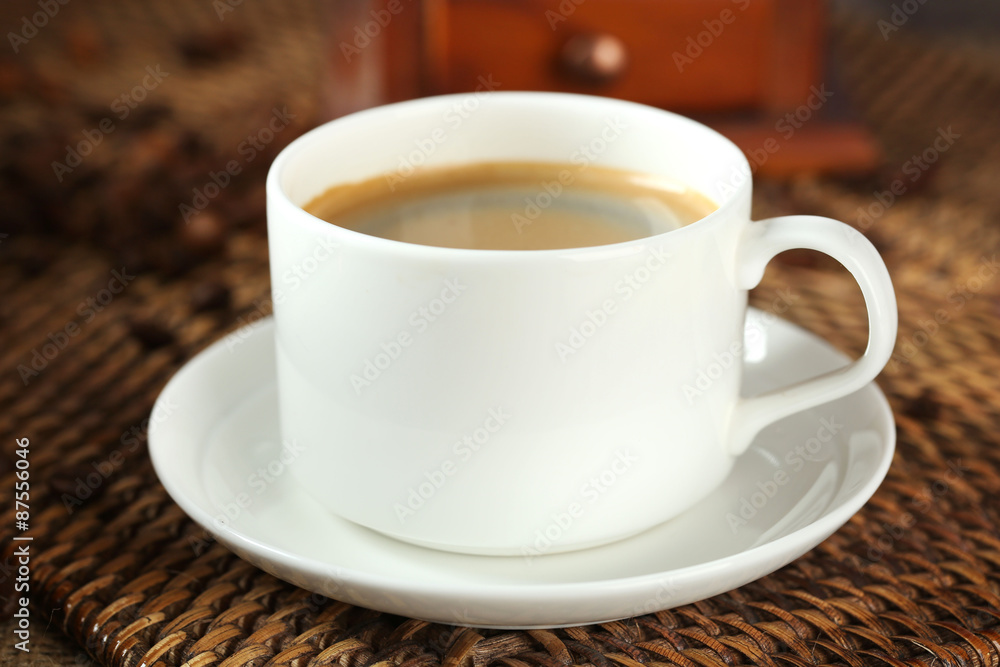 Cup of coffee with beans on table close up Cup of coffee with beans on table close up