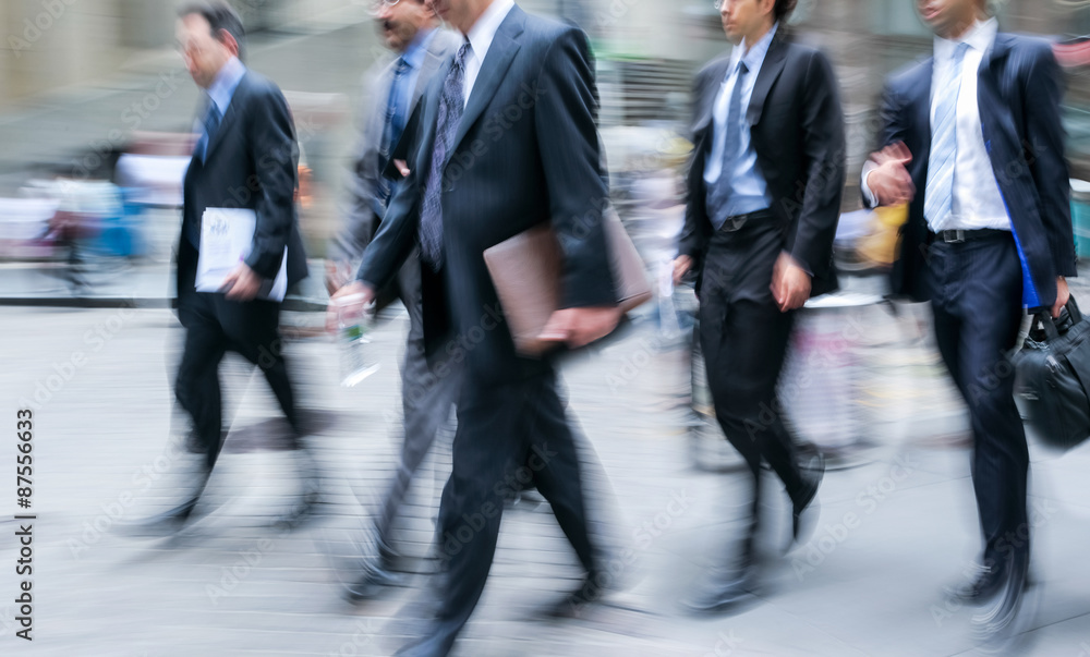 motion blurred business people walking on the street motion blurred business people walking on the street