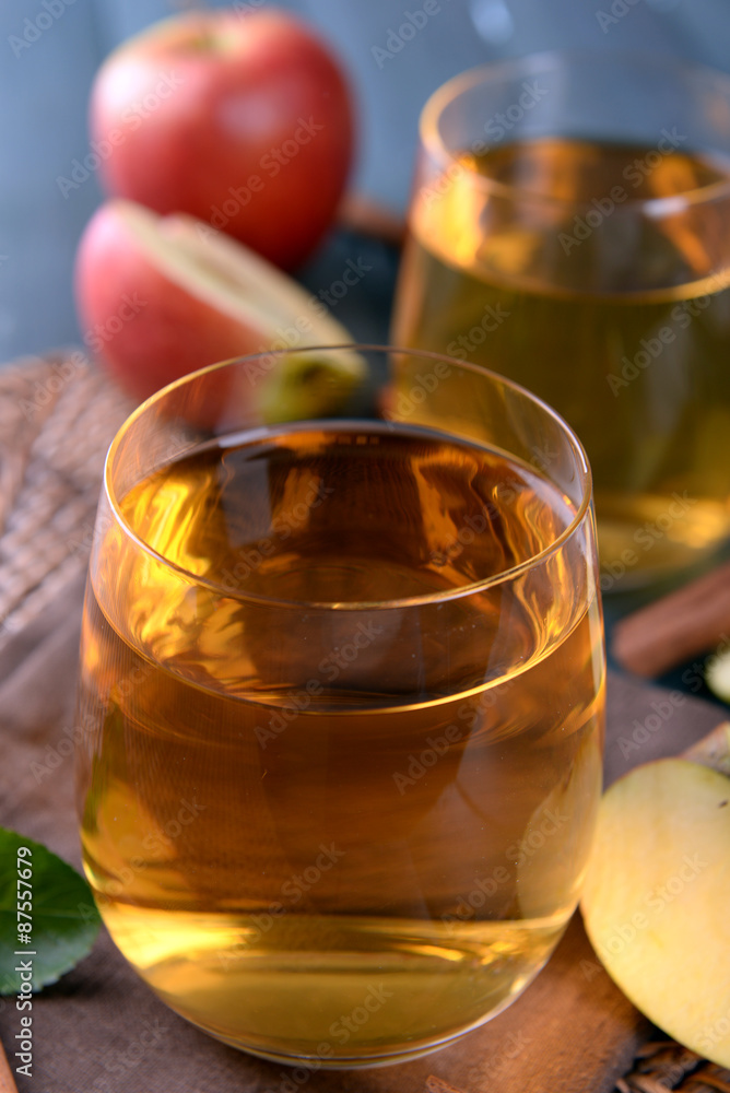 Glasses of apple juice on wooden table, closeup Glasses of apple juice on wooden table, closeup