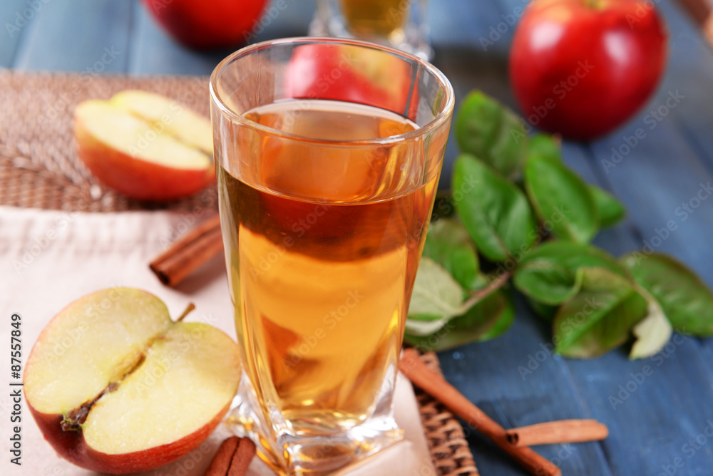 Glass of apple juice on wooden table, closeup Glass of apple juice on wooden table, closeup