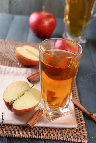 Glass of apple juice on wooden table  closeup