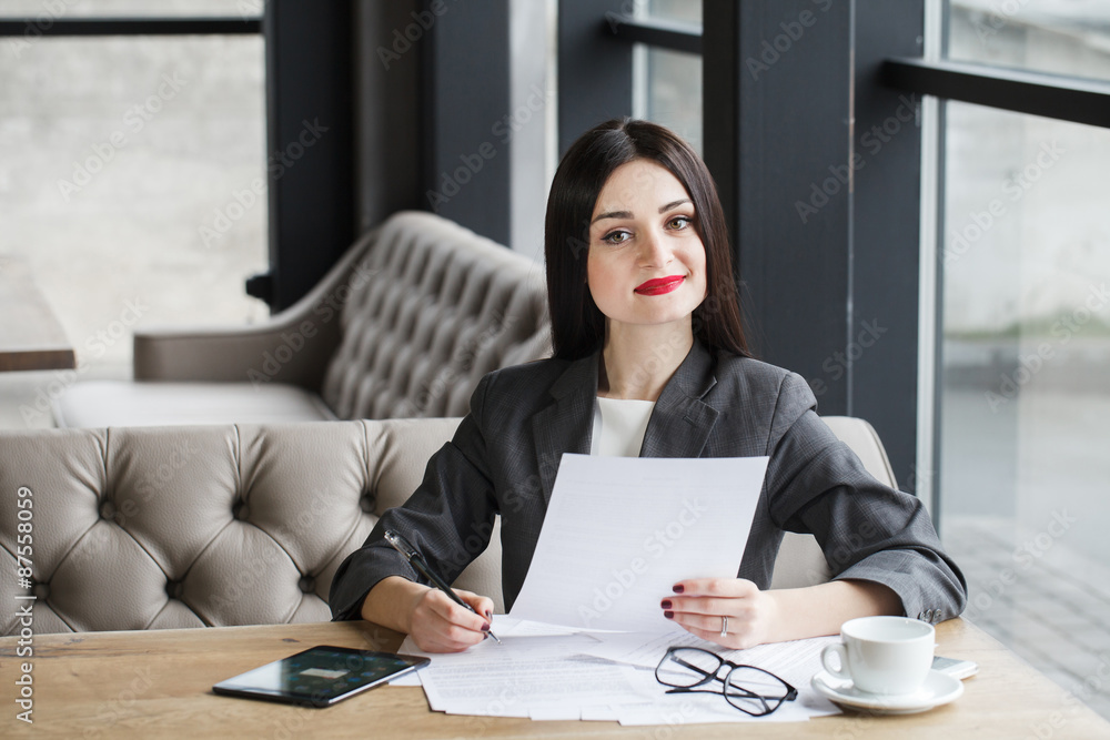 Businesswoman with documents and pen. Businesswoman with documents and pen.