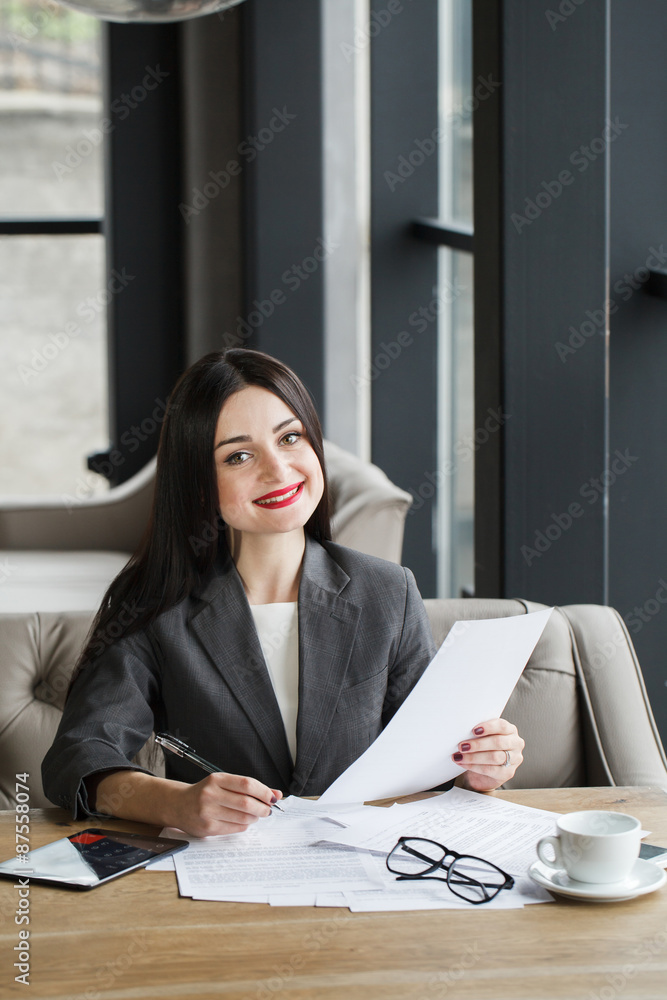 Businesswoman with documents and pen. Businesswoman with documents and pen.