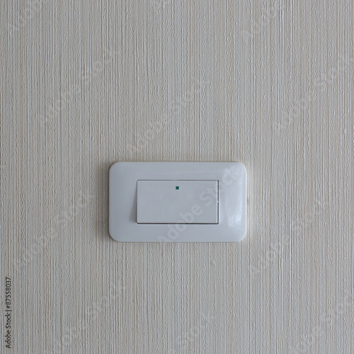 Light switch / White light switch on white wall / Concept / On O