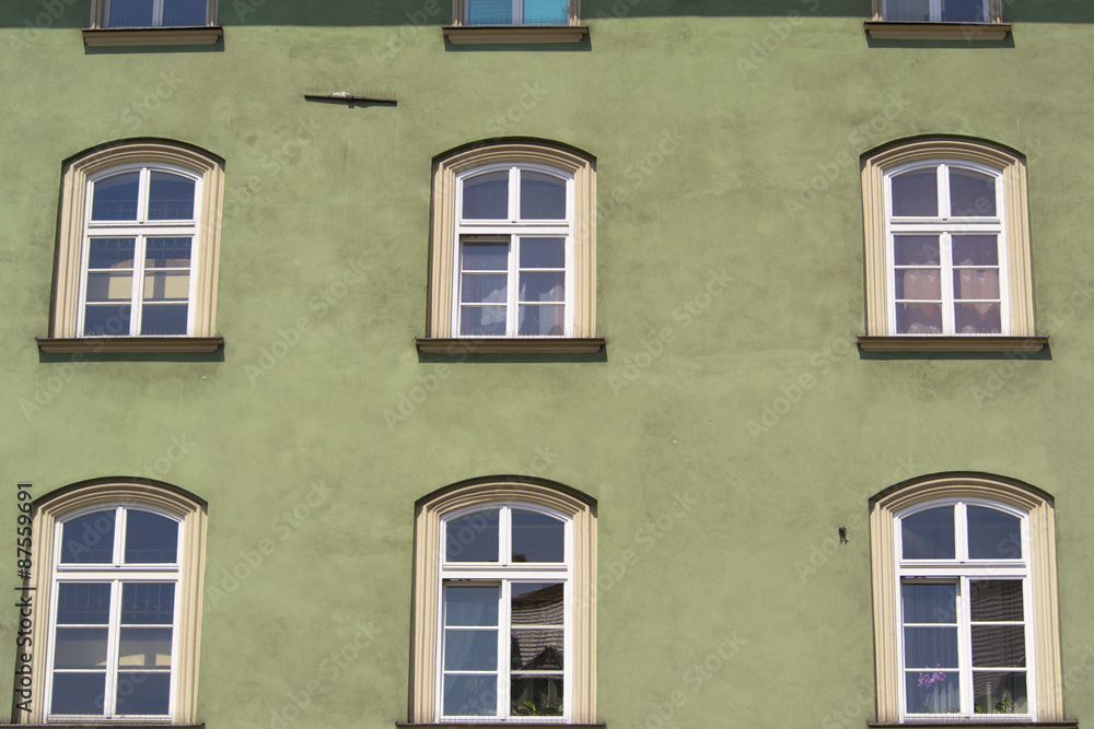 Windows in green wall of old building