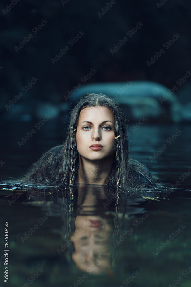 Beautiful water nymph in dark cyan stream