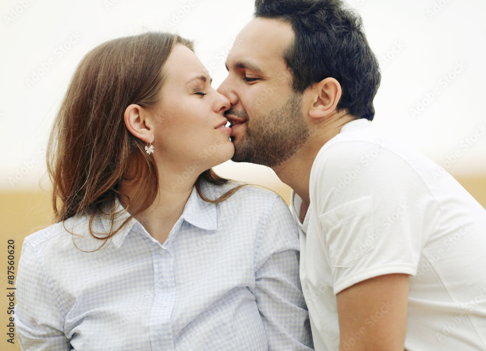 sensual young couple kissing in summer field