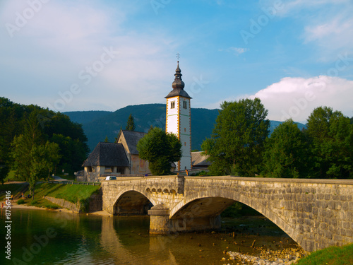 Church tower and stone bridge at Lake Bohinj