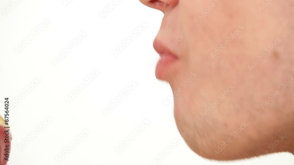 Man eating a red apple profile is insulated on white Man eating a red apple profile is insulated on white