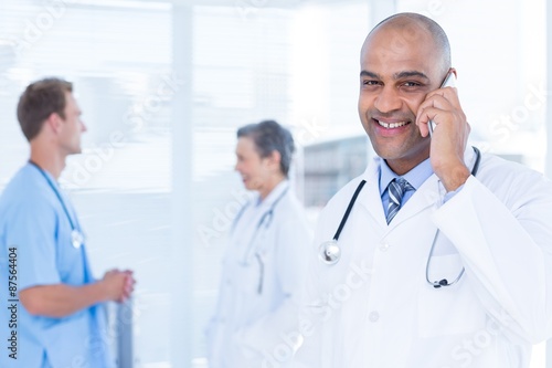 Smiling doctor talking on the phone