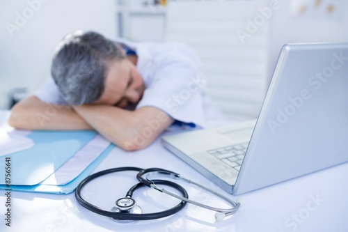 Female doctor sleeping on desk 