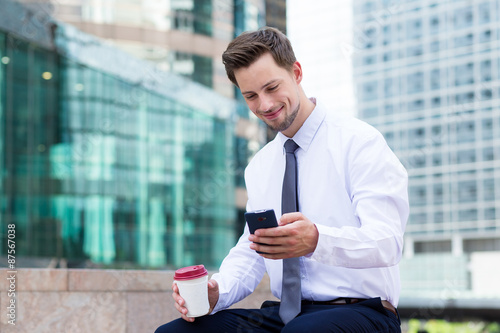 Photography Caucasian young businessman with coffee and mobile phone at hong