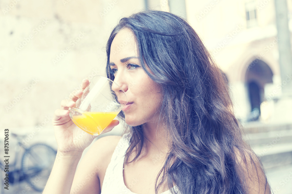 portrait of attractive girl while drinking an orange juice portrait of attractive girl while drinking an orange juice