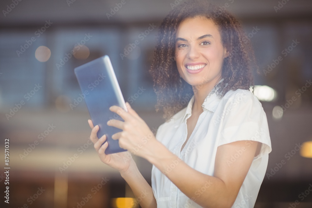 Smiling woman using a digital tablet Smiling woman using a digital tablet