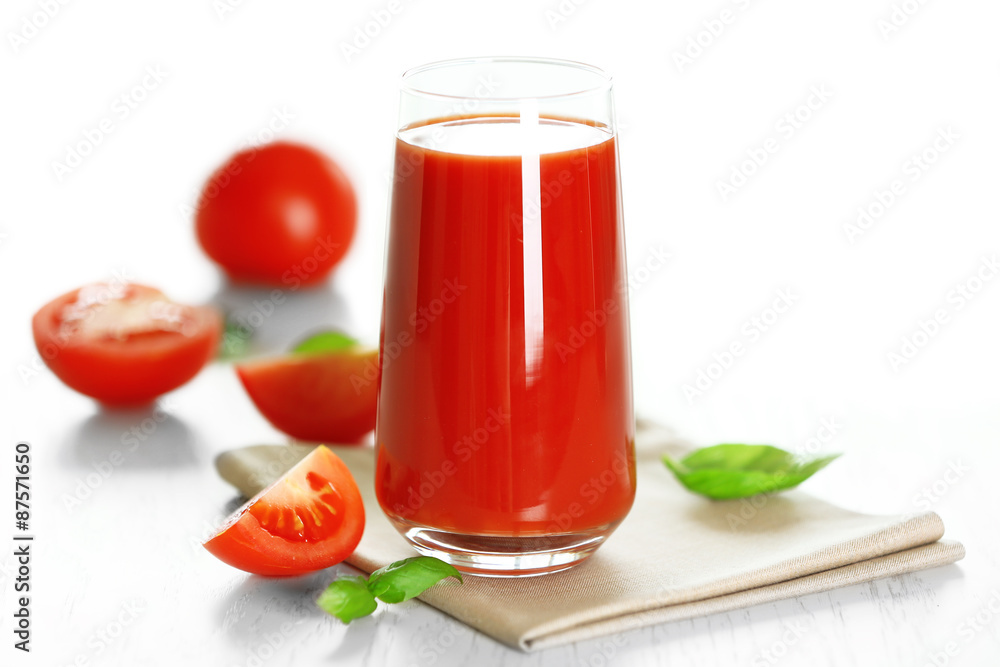 Tomato juice and fresh tomatoes on wooden table close-up Tomato juice and fresh tomatoes on wooden table close-up