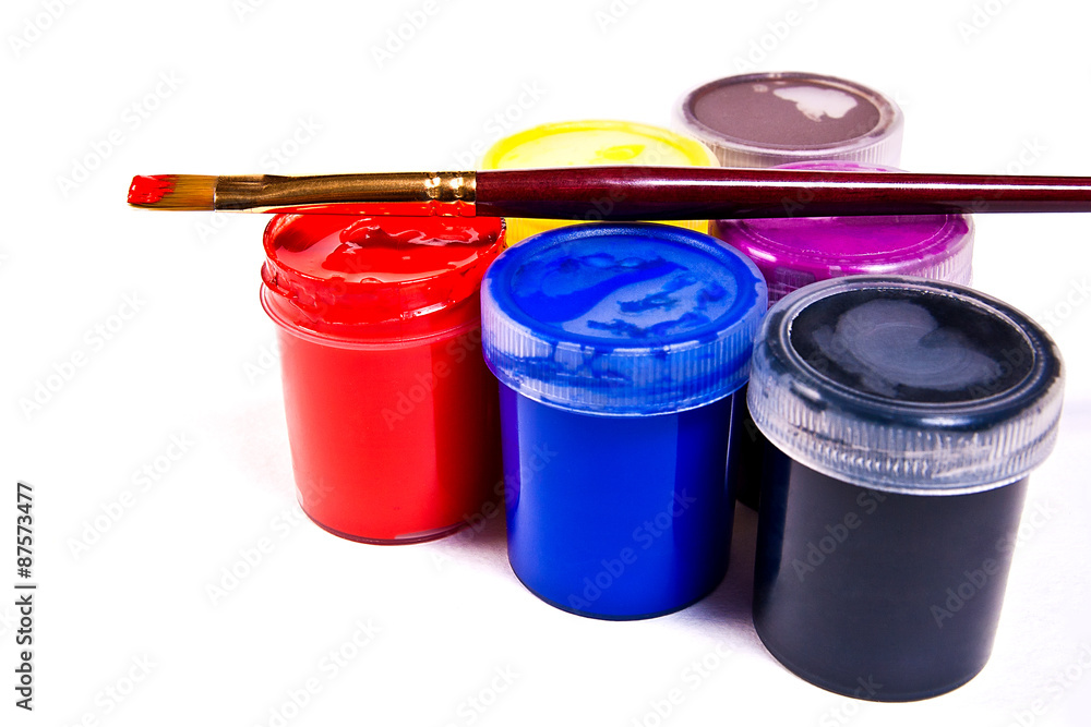 Bottles with gouache paints and brushes for artistic paintings.