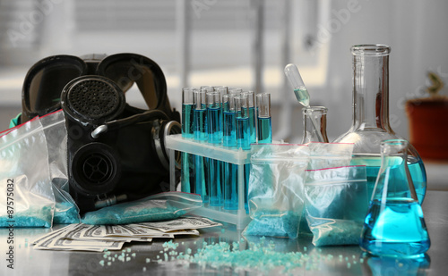 Drug laboratory: blue  methamphetamine and money on table close up photo