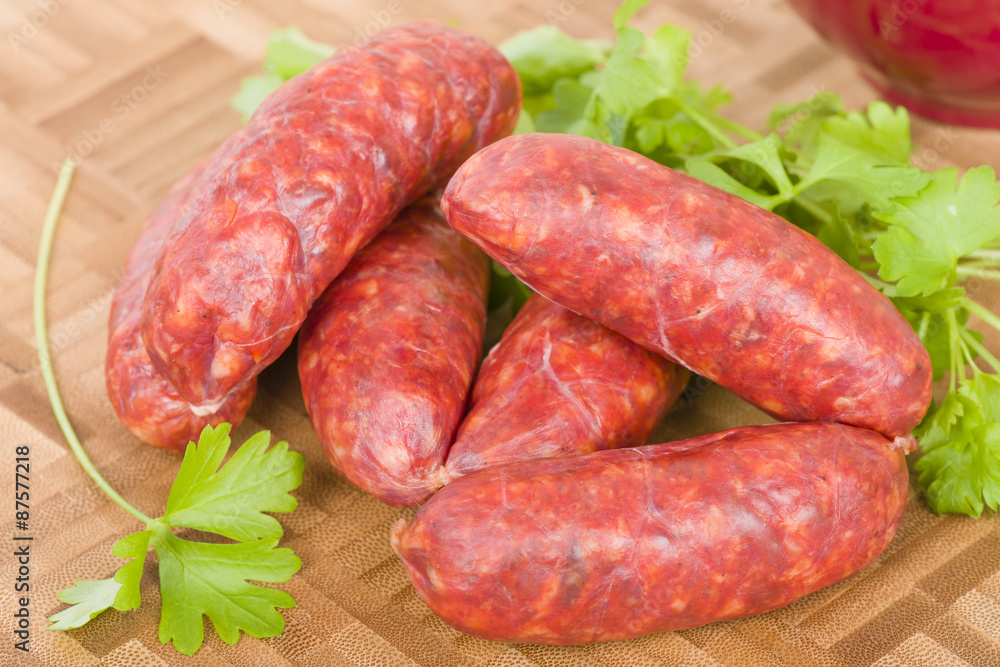 Chorizo - Spicy sausage on a wooden board. Chorizo - Spicy sausage on a wooden board.