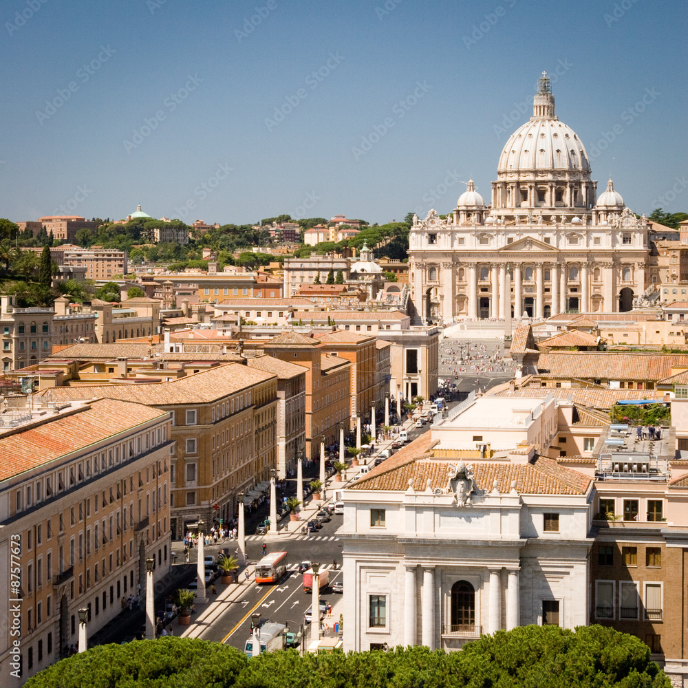 The Vatican City. An elevated view looking over  the rooftops of the Vatican City on the main approach to St. Peter's square and the Basilica in the distance.