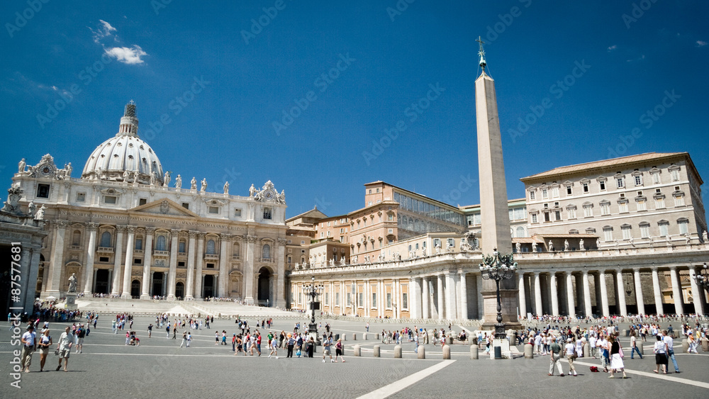 St. Peter's Square, Vatican City. Wide angle view with the Basilica and Popes palace creating a background to the visiting tourists and pilgrims.