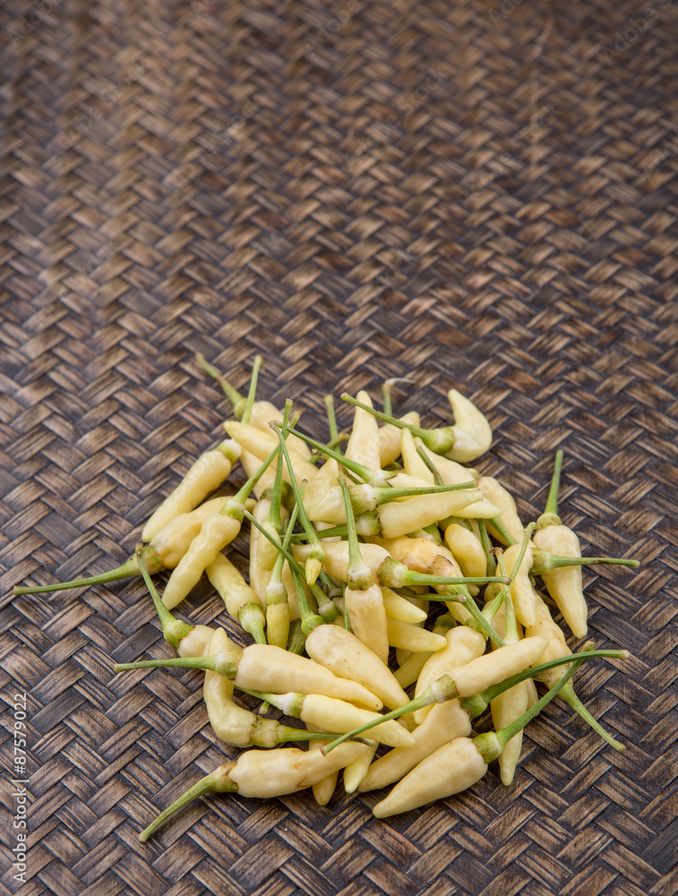 Thai chili or bird's eye chili over wicker background Thai chili or bird's eye chili over wicker background