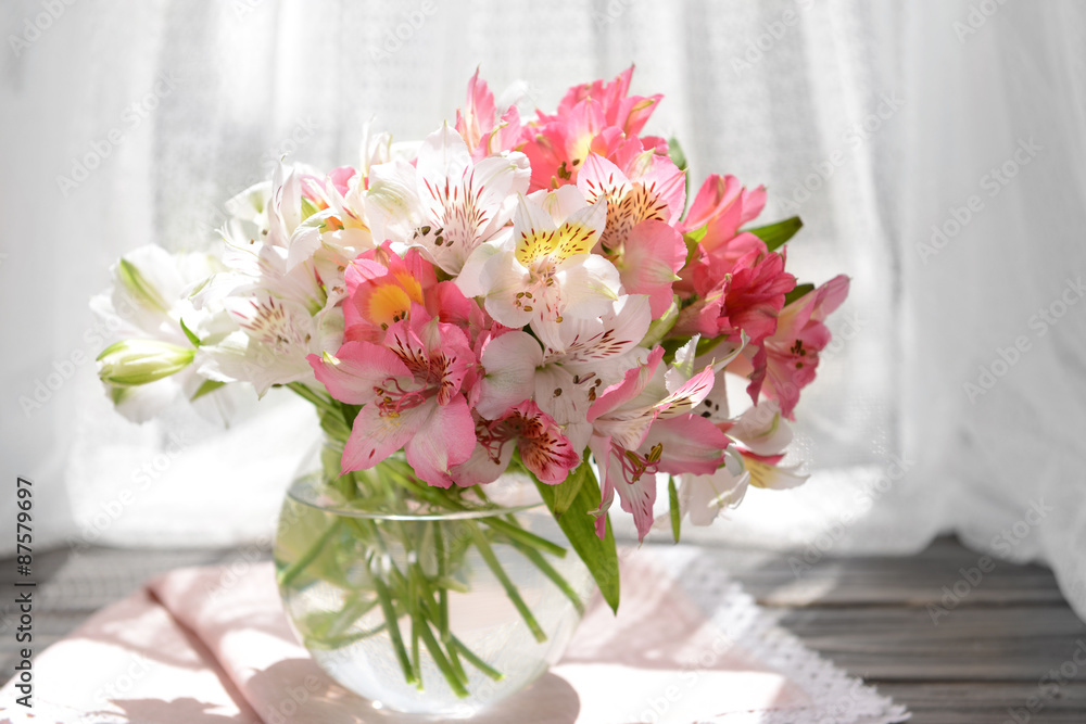 Fototapeta premium Beautiful bright bouquet in vase on fabric background