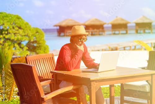 Young man with laptop at luxury beach resort © nadezhda1906