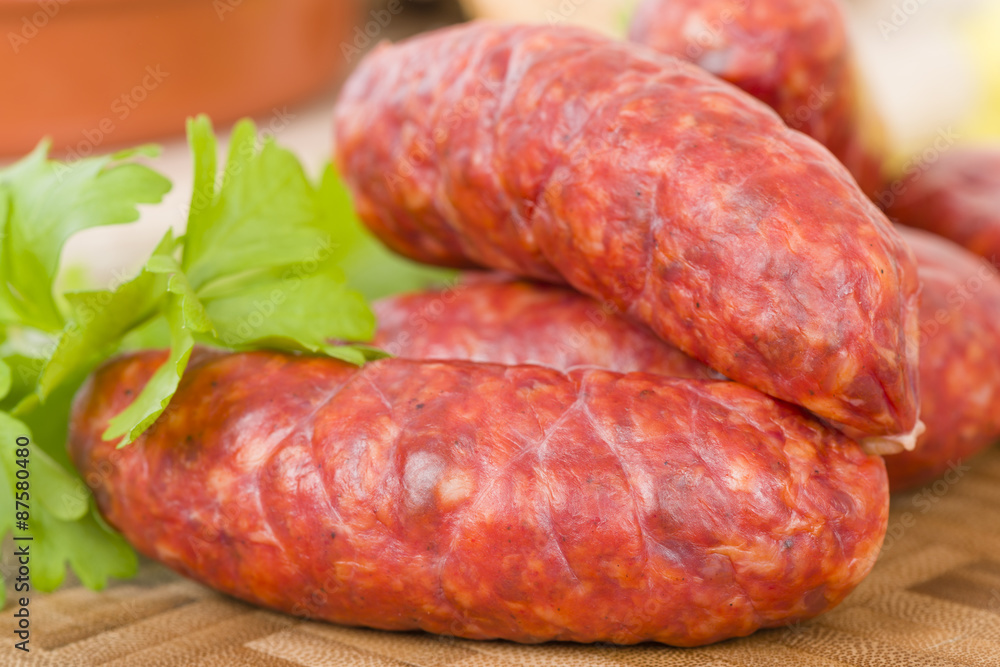 Chorizo - Spicy sausage on a wooden board. Chorizo - Spicy sausage on a wooden board.