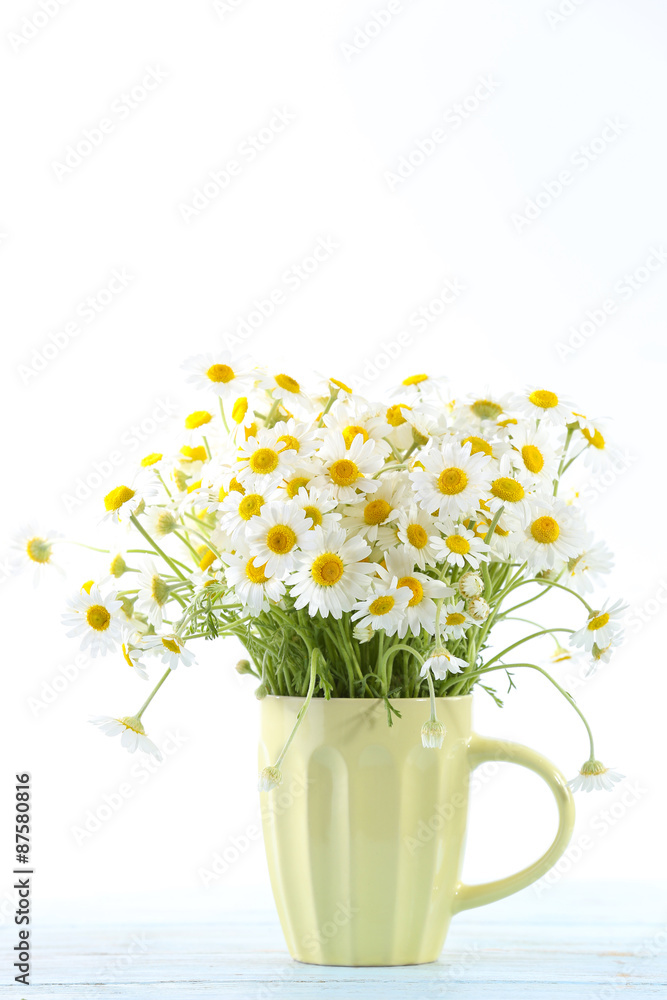 Beautiful bouquet of daisies in cup on light background Beautiful bouquet of daisies in cup on light background