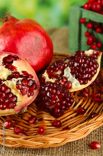 Pomegranate seeds on wicker tray, closeup