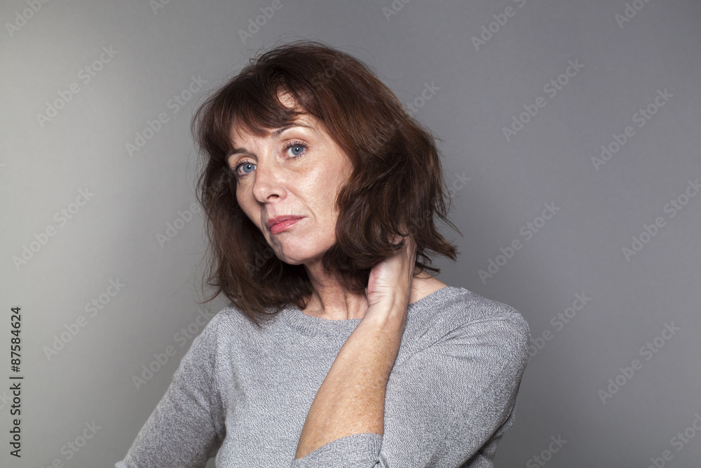 disillusioned mature woman with brown hair and grey sweater thinking,looking bored and concerned disillusioned mature woman with brown hair and grey sweater thinking,looking bored and concerned