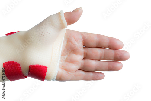 Palm of woman left hand with straight fingers and wrist and thumb splint