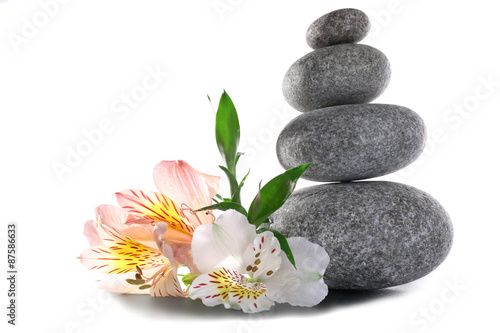 Stack of spa stones with flower isolated on white