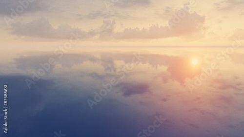 Sunset clouds over mirror water surface time lapse