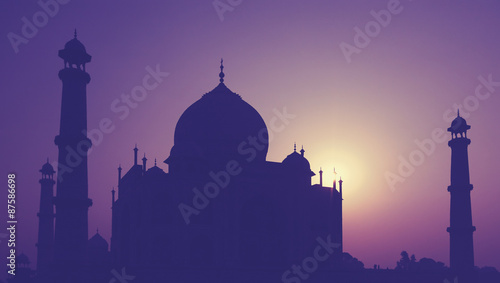 Vintage retro toned silhouette of Taj Mahal at sunrise, India.