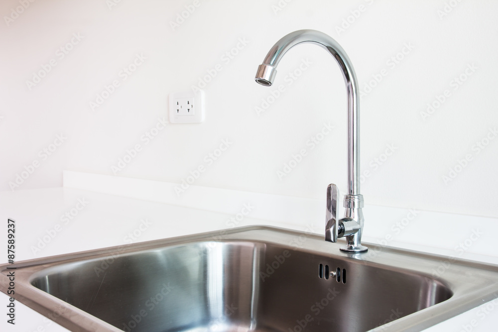 Water tap and sink in a modern kitchen. Water tap and sink in a modern kitchen.