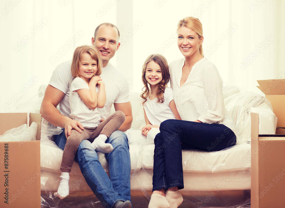 smiling parents and two little girls at new home