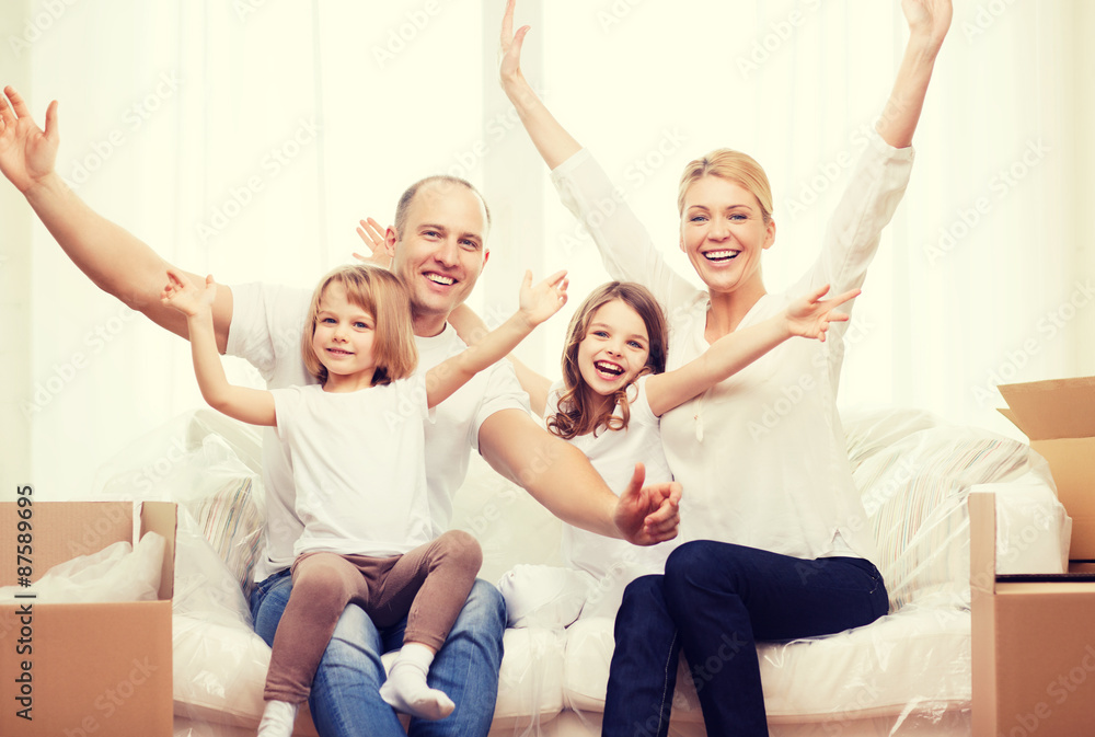 smiling parents and two little girls at new home