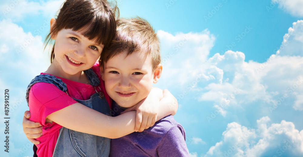 two happy kids hugging over blue sky and clouds two happy kids hugging over blue sky and clouds