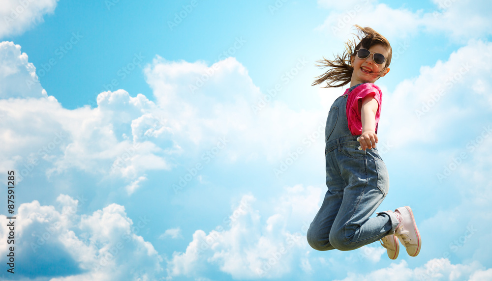 happy little girl jumping high over blue sky happy little girl jumping high over blue sky