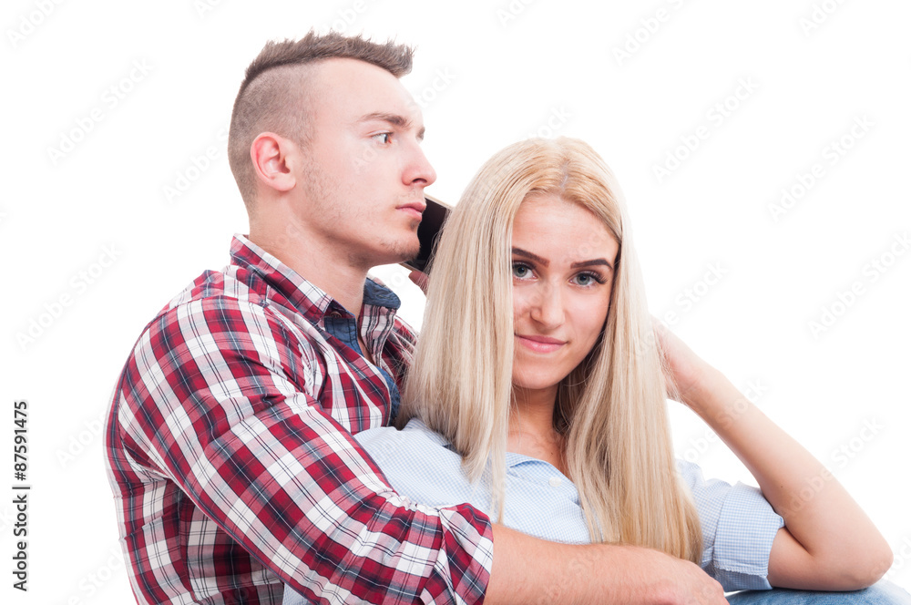 Man hugging woman and talking on the phone with another Man hugging woman and talking on the phone with another