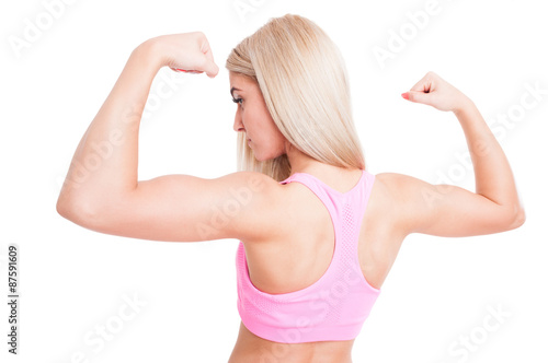Beautiful bodybuilder girl flexing arms