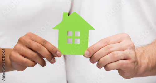 couple hands holding green house