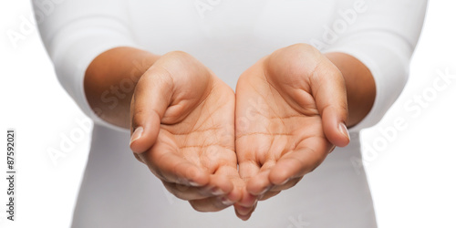 womans cupped hands showing something