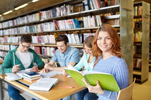 students with books preparing to exam in library